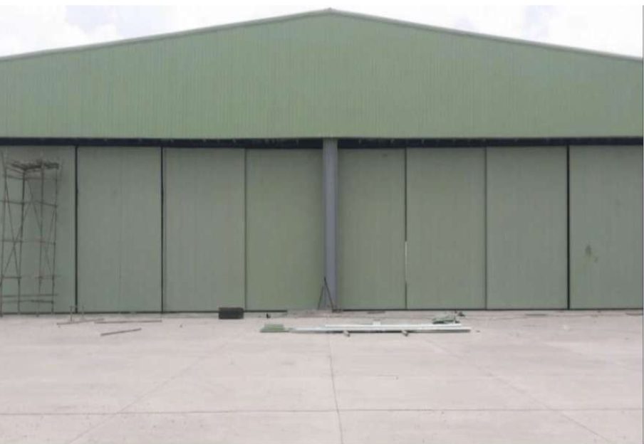A&A Enterprises Engineering — green hangar with sliding doors